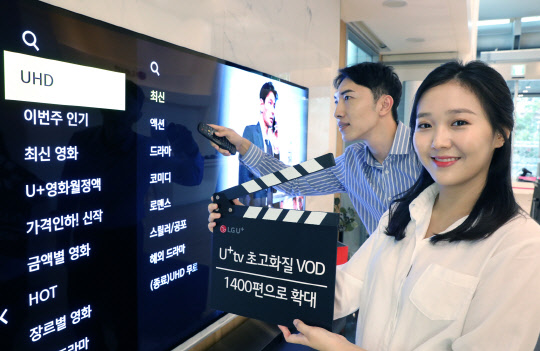 LG유플러스 모델이 U+tv에서 UHD 영화를 검색하고 있다.  LG유플러스 제공